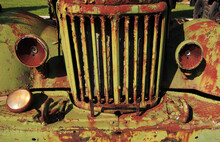 The Front Of An Old Rusty Car