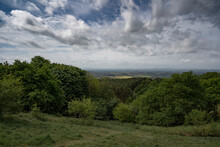 British Hillside View Over Worcestershire With Trees And Meadows Under A Cloudy Sky