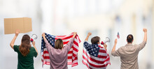 Independence Day, Patriotic And Human Rights Concept - People With Flags Of United States Of America Protesting On Demonstration Over City Street Background