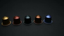 Camera Travels Over Table With Coloured Expresso Coffee Capsules A Coffee Bag