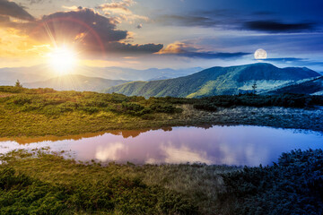 Wall Mural - day and night time change concept above landscape with lake in summer. peaceful reflection in the wa