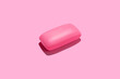 Pink soap bar in center of pink background