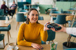 © cherryandbees - woman playing contactless with card in restaurant