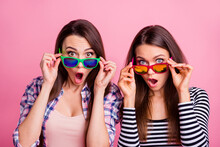Portrait Of Two Impressed Pretty Girls Hands Touch Glasses Open Mouth Isolated On Pink Color Background