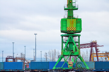 Cargo crane with blue containers with goods in the port