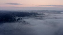 High Flight Over The Thick Summer Morning Fog. Aerial Drone View.