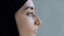 Close-up Profile Of The Face Of An Arab Woman In A Black Hijab. An Islamic World That Professes Islam And Forces Women To Cover Their Hair With A Scarf From Other Peoples Views In Their Direction.