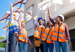 © Chalermphon - Civil worker Engineering team stood up and raised their hands. Happy with the contractor team. Happy for the success of the housing project.Engineer Working together and teamwork,Safety,PPE concept.