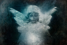 A Scary Statue Of A Graveyard Angel With A Skull And Wings Looking Down In Sadness. With A Grunge, Texture.