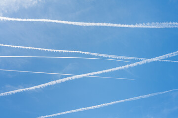 Blue sky with lines of airplanes.