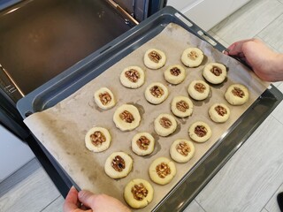 Wall Mural - Baking shortbread cookies with walnuts in the oven.