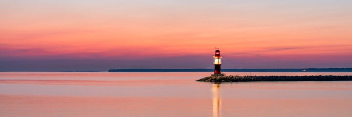 Wall Mural - lighthouse ostmole warnemünde at sunrise, rostock, germany