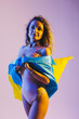 © DSMT - Full length body size view of nice beautiful glad cheerful cheery straight-haired girl jumping having fun walking holding in hands Ukrainian flag isolated over light white gray pastel color background