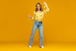 © mary_markevich - stylish happy smiling blond woman posing in jeans on yellow background