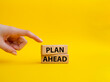 Plan ahead symbol. Wooden blocks with words 'Plan ahead'. Beautiful yellow background. Businessman hand. Business and 'Plan ahead' concept. Copy space.