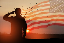 USA Army Soldier Saluting On A Background Of Sunset Or Sunrise And USA Flag. Greeting Card For Veterans Day, Memorial Day, Independence Day. America Celebration. 3D-rendering.