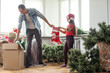 © Angelov - Father and daughter assembling christmas tree, smiling - christmas, holiday, winter concept, family activity.