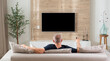 © SDF_QWE - man in modern living room watching tv back view