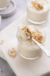 © Romana - Creamy dairy yoghurt dessert with mascarpone, cream cheese and peanut butter in glasses on marble tray