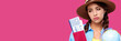 © khmelev - Upset girl with plane tickets and passport holding globe on pink isolated background. Female traveler in casual clothes and straw hat. Concept of tourism