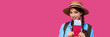 © khmelev - Young female traveler wearing casual clothes and straw hat holding passport with ticket on pink isolate background. Tourism concept. Studio shot