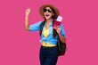© khmelev - Amazed and smiling woman traveler in straw hat and sunglasses holding plane ticket and passport on pink isolated background