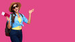 © khmelev - Excited female tourist holding passport and traveling tickets over pink isolate background. Woman student in summer casual clothes. Smiling caucasian woman in sunglasses.