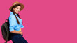 © khmelev - Positive woman traveler in casual clothes, straw hat and backpack on pink isolated background. Young smiling caucasian tourist