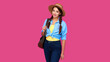 © khmelev - Positive woman traveler in casual clothes, straw hat and backpack on pink isolated background. Young smiling caucasian tourist