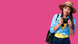 © khmelev - Tourism concept. Happy caucasian woman tourist in summer casual clothing holding photo camera, isolated on pink background with copy space