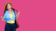 © khmelev - Smiling excited caucasian woman with backpack on pink background wearing casual clothes, straw hat have fun and holding her pigtails. Victory concept
