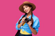 © khmelev - Tourism concept. Happy caucasian woman tourist in summer casual clothing holding photo camera, isolated on pink background with copy space