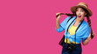 © khmelev - Tourism concept. Excited young caucasian woman tourist with photo camera, isolated on pink background. Female student hipster in casual clothes and straw hat