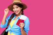 © khmelev - Happy woman tourist in summer casual clothes holding passport and airplane vacation tickets on holiday on pink isolated background