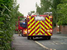 Pair Of British Fire Engines Parked At Side Of Road 