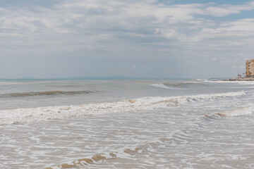 Poster - Seascape. Foam waves at sandy beach. Waterscape for background. Nature concept. Soft focus. Motion waves. Copy space.