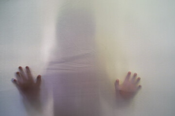 Shadow Small Child behind the curtain.Halloween background. Grunge background With People Abstract Concept.
