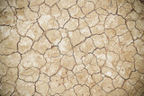 Fototapeta  - Cracked soil texture drought season in agricultural field with seamless patterns background