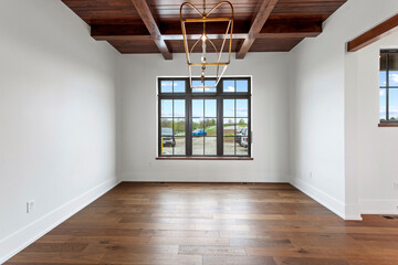 Empty dining room with black windows and wood ceiling