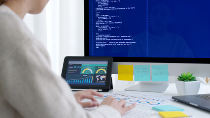 Asia young business woman sit busy at home office desk work code on desktop reskill upskill for job career remote self test IT deep tech ai design skill online html text for cyber security workforce.