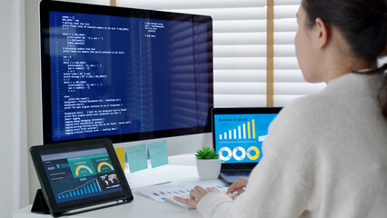 Asia young business woman sit busy at home office desk work code on desktop reskill upskill for job career remote self test IT deep tech ai design skill online html text for cyber security workforce.