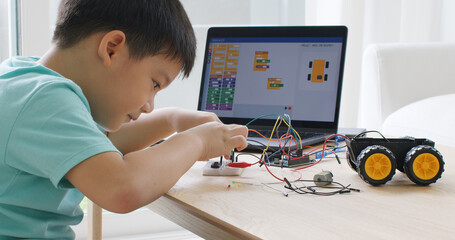 asia home school young small kid happy smile self study online lesson excited make ai circuit toy. s