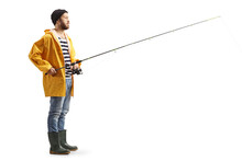 Full Length Profile Shot Of A Fisherman In A Raincoat Standing With A Fishing Rod