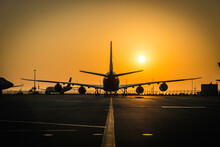 Airplane In The Sunset Of Hong Kong Airport