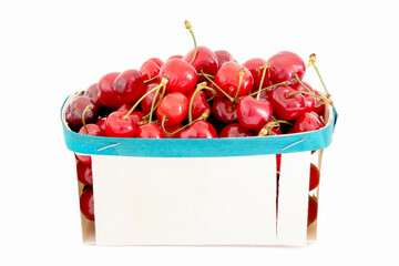 Wall Mural - red cherries in wooden basket on white background