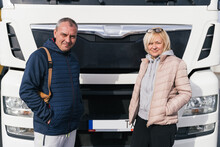 Mature Woman And Man As Couple Parters Truck Drivers. Transportation Workers In Europe