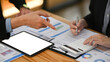 © Prathankarnpap - Cropped shot businessman explaining financial data, sharing startup business plan with colleague
