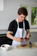 © Ben Gingell - A Teenage Boy Cooking In A Kitchen