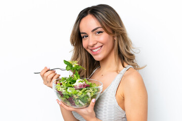 Wall Mural - Young caucasian woman isolated on white background holding a bowl of salad with happy expression