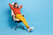 canvas print picture Full length body size view of attractive cheerful dreamy girl resting in office armchair isolated over bright blue color background